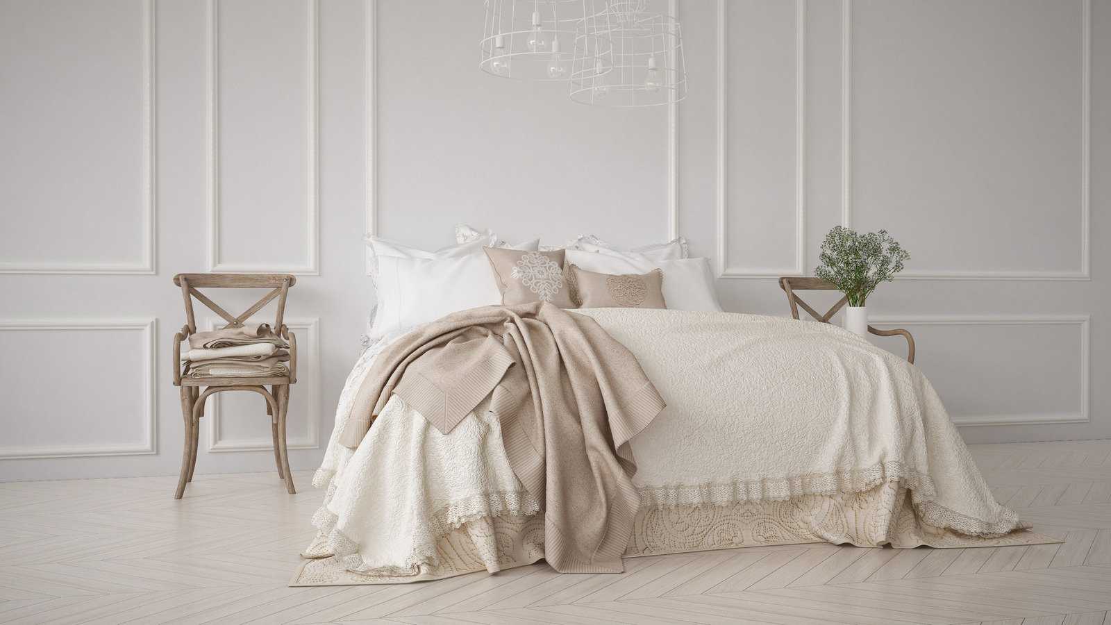 białe łóżko z kolorową poduszką